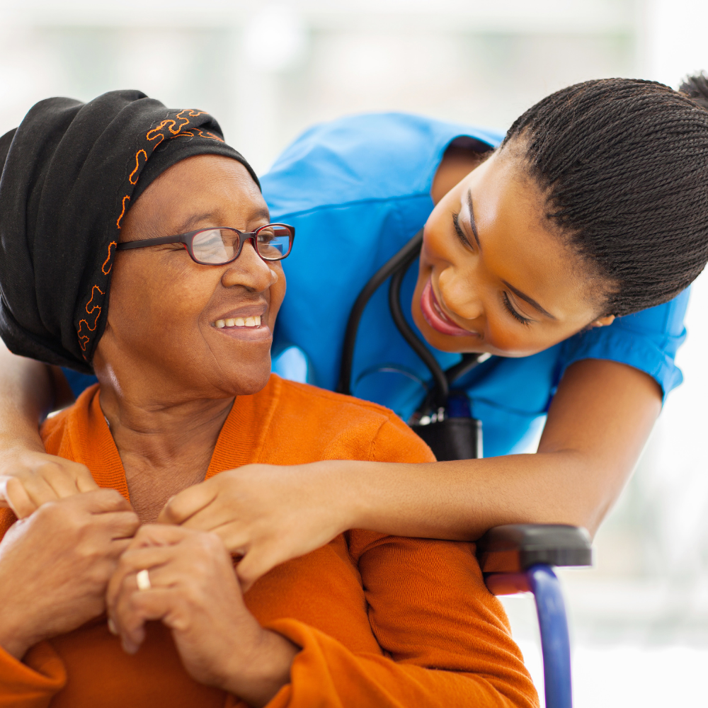 a nurse and senior resident embrace and smile