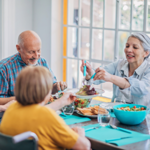 older adults sharing meal over a table